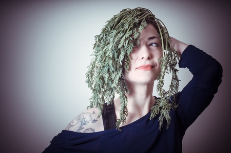 beautiful woman with carrots on hair on gray backgroundの写真素材