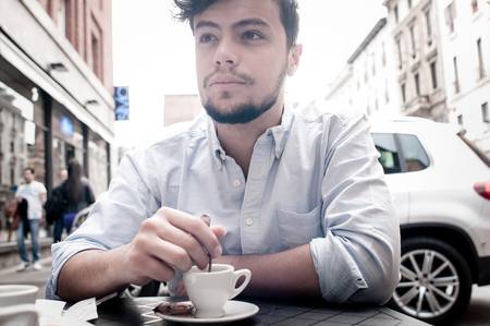 stylish man drinking a coffee at the bar in the cityの写真素材