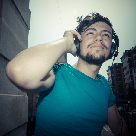 young man hipster listening to music with headphonesの写真素材