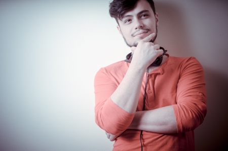 Stylish man listening to music on vignetting background