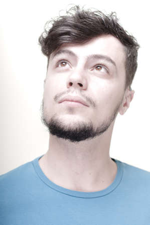 portrait of stylish young man with blue shirt on vignetting background