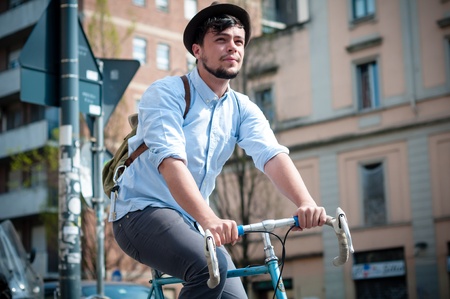 hipster young man on bike in the cityの写真素材
