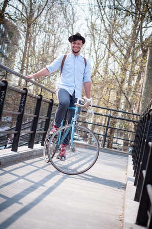 hipster young man on bike in the cityの写真素材