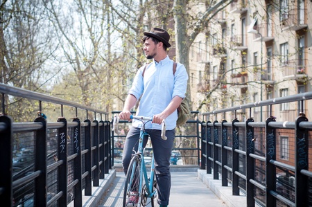 hipster young man on bike in the cityの写真素材