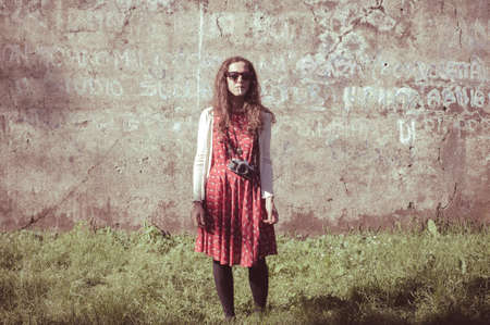 hipster vintage woman with old camera in the parkの写真素材