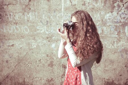 hipster vintage woman with old camera in the parkの写真素材