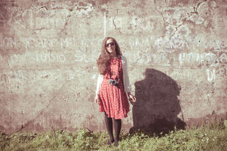 hipster vintage woman with old camera in the parkの写真素材