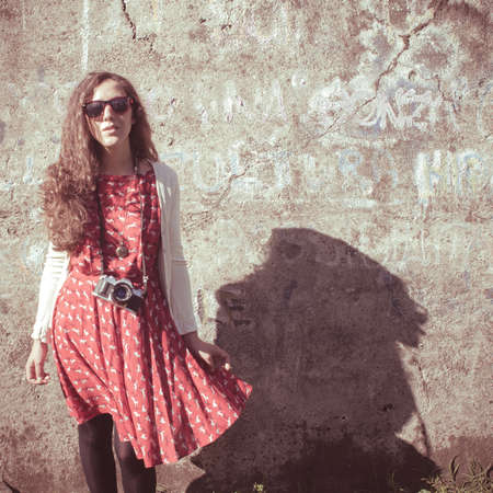 hipster vintage woman with old camera in the parkの写真素材