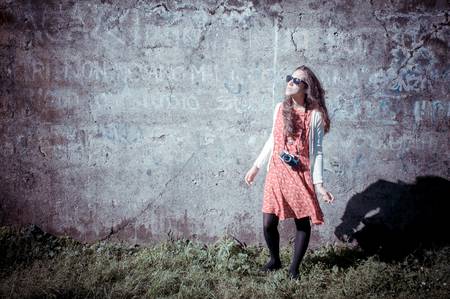 hipster vintage woman with old camera in the parkの写真素材