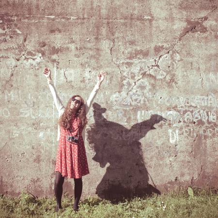 hipster vintage woman with old camera in the parkの写真素材