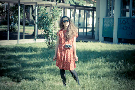 hipster vintage woman with old camera in the parkの写真素材