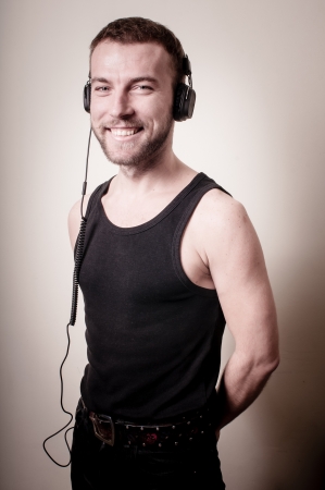 stylish hipster listening to music on gray backgroundの写真素材