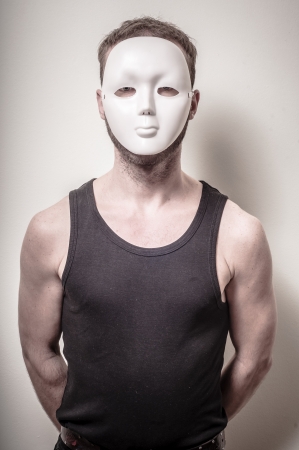 man with white mask on gray backgroundの写真素材