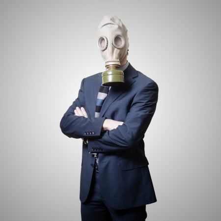 businessman with gas mask on gray backgroundの写真素材