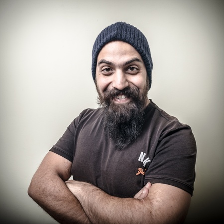 smiling bearded man with cap isolated on gray backgroundの写真素材