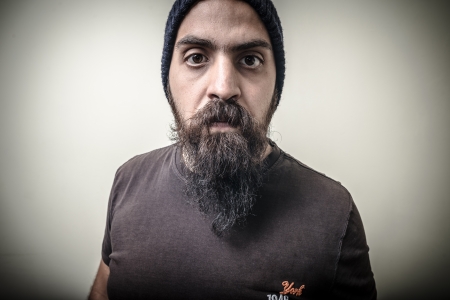serious bearded man with cap isolated on gray backgroundの写真素材