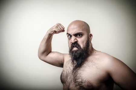 super power angry muscle bearded man  on gray backgroundの写真素材