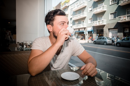 young stylish man at the bar drinking coffee