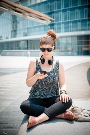 beautiful stylish modern young woman on the phone in the cityの写真素材