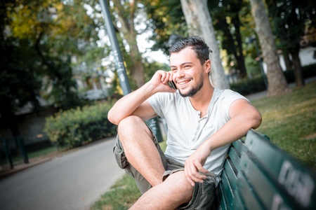 stylish man on the phone at the parkの写真素材