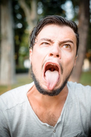 close up portrait of youg stylish man bigmouthの写真素材