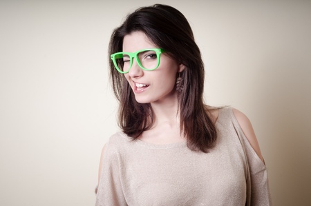 beautiful young woman with green eyeglasses on white background