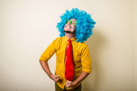 crazy funny young man with blue wig on white backgroundの写真素材