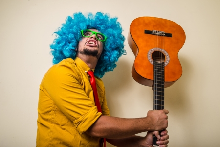 crazy funny young man with blue wig on white backgroundの写真素材