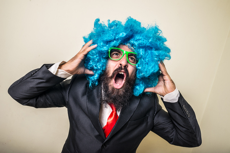 crazy funny bearded man with blue wig on white backgroundの写真素材