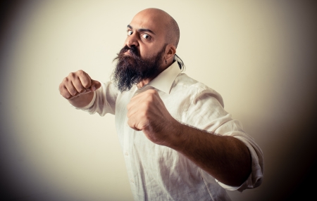 angry fighter long beard and mustache man isolated on grayの写真素材