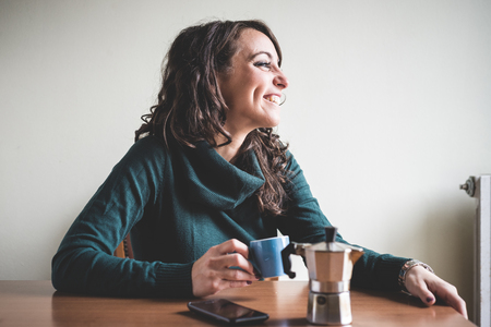 beautiful woman having breakfast at homeの写真素材