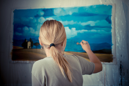 beautiful blonde woman painter in her studio