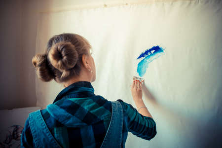 beautiful blonde woman painter in her studioの写真素材