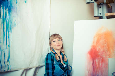 beautiful blonde woman painter in her studioの写真素材