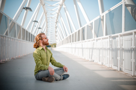 stylish hipster model with long red hair and beard lifestyle in the streetの写真素材