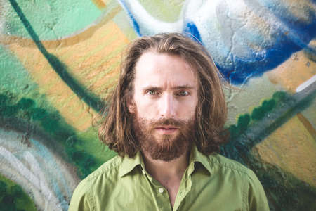 stylish hipster model with long red hair and beard lifestyle in the streetの写真素材