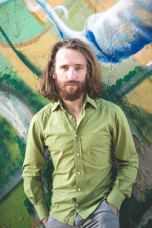 stylish hipster model with long red hair and beard lifestyle in the street