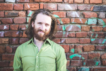 stylish hipster model with long red hair and beard lifestyle in the streetの写真素材