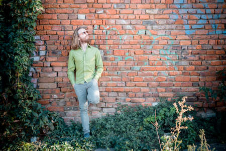 stylish hipster model with long red hair and beard lifestyle in the streetの写真素材