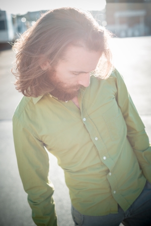 stylish hipster model with long red hair and beard lifestyle in the streetの写真素材