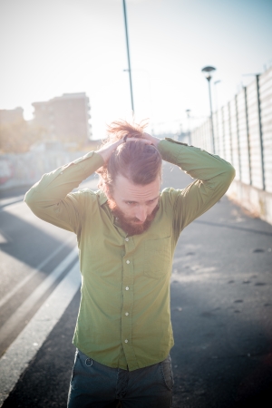 stylish hipster model with long red hair and beard lifestyle in the streetの写真素材