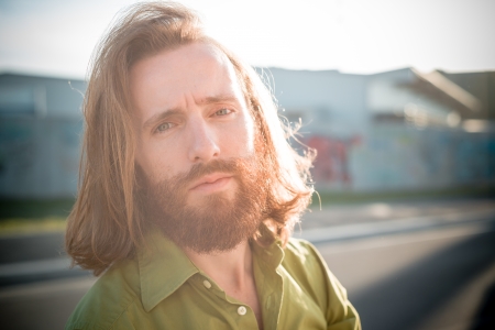 stylish hipster model with long red hair and beard lifestyle in the streetの写真素材