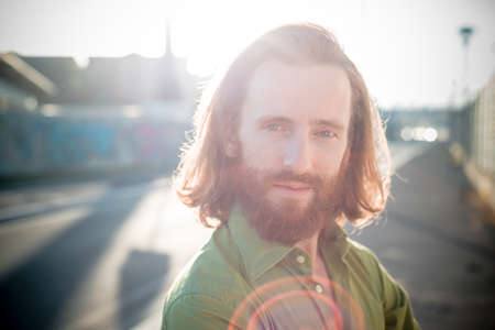 stylish hipster model with long red hair and beard lifestyle in the streetの写真素材