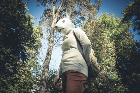 young hipster rabbit mask woman in the woodland autumnの写真素材