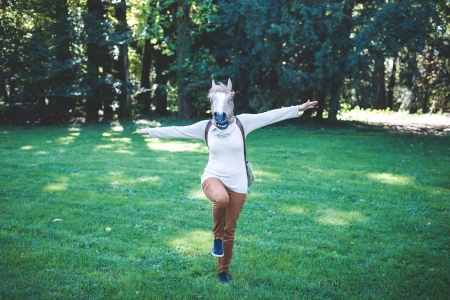 young hipster horse mask woman in the woodland autumnの写真素材