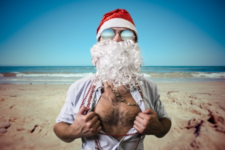funny santa claus super hero beach summer christmas on holidayの写真素材
