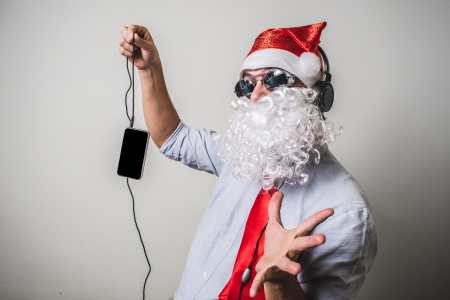 funny santa claus babbo natale listening music on white backgroundの写真素材