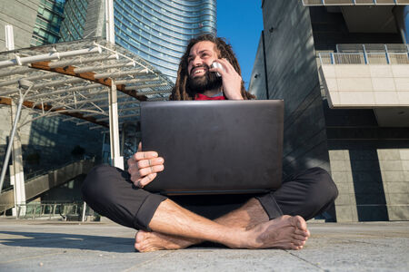 Stylish elegant dreadlocks businessman in business landscapeの写真素材