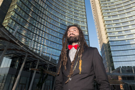 Stylish elegant dreadlocks businessman in business landscapeの写真素材