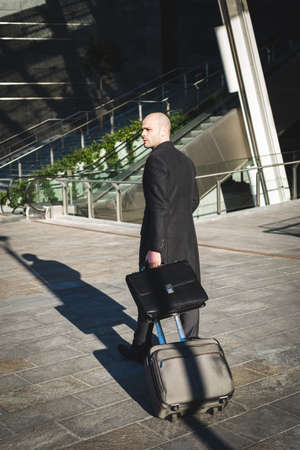 successful elegant fashionable businessman using tablet  in business districtの写真素材